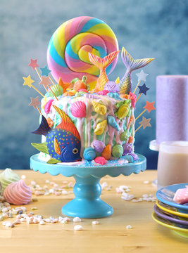 Mermaid theme candyland cake with colorful glitter tails, shells and sea creatures toppers for children's, teen's, novelty birthday and party celebrations.