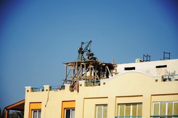 Fototapeta na wymiar Ouvriers travaillant sur le toit d’un hôtel à Marsa Alam (Egypte) 