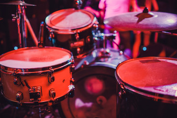 Fototapeta na wymiar Drum kit on stage in the spotlight color.