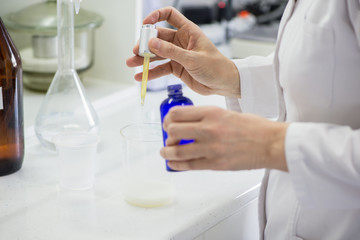woman testing samples of dairy products in the laboratory. test laboratory of a milk factory