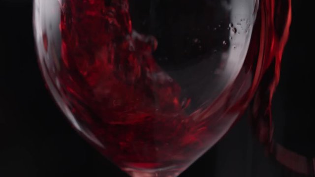 A glass of red wine, slow motion