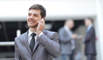 portrait of handsome businessman on blurred office background