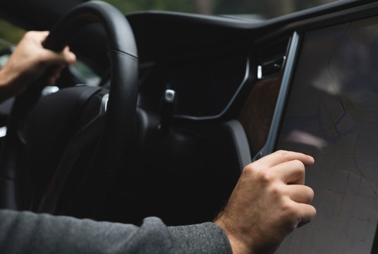 Man using navigator map while driving a car