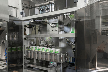 the conveyor of filling and packaging of drinks in cardboard container. equipment at the dairy plant