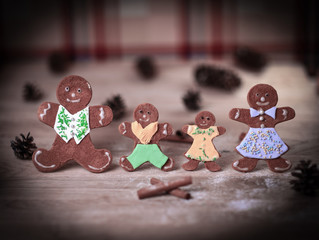 gingerbread men and cinnamon sticks on the Christmas table .