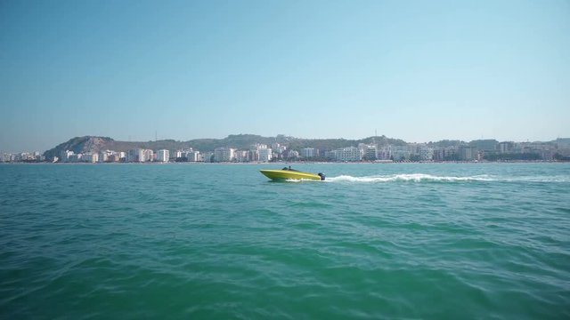 Yacht in beautiful blue ocean. View of luxury yacht navigating close to the coast, motor boat