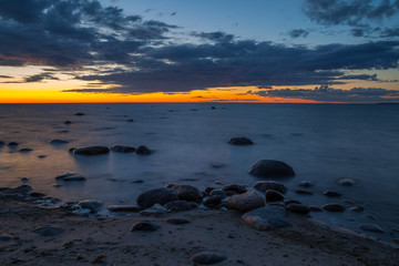 Fototapeta na wymiar Late sunset view of rocky sea coast. Estonia. Long exposure.