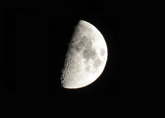 Silver waxing moon on black sky background
