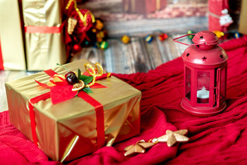 golden gift box is standing on a red plaid