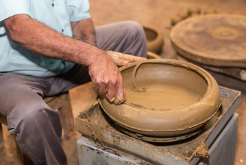 Local artisan working on clay pottery in Goa,India