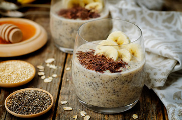 Overnight banana oats quinoa Chia seed pudding decorated with fresh banana slices and chocolate