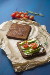 sandwiches with ricotta, avocado, cherry tomatoes and cucumbers