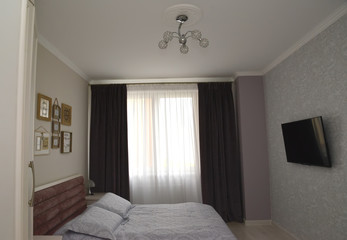 The bedroom with dark portieres. Scandinavian style