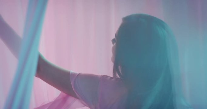 multicolored fantasy beautiful young woman dancing between curtains elegant sensual female enjoying playful beauty dance in colorful background