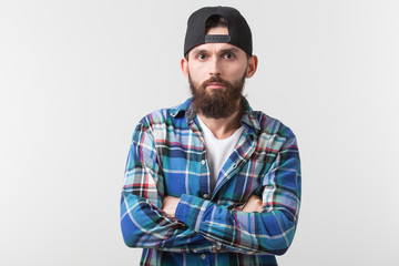 Fototapeta na wymiar Beauty, fashion and people concept - Portrait of a young bearded hipster stylish guy over white background.