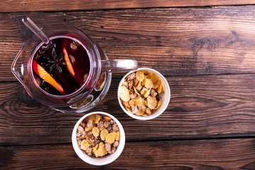 Decorated composition of mulled wine in jug on wooden table