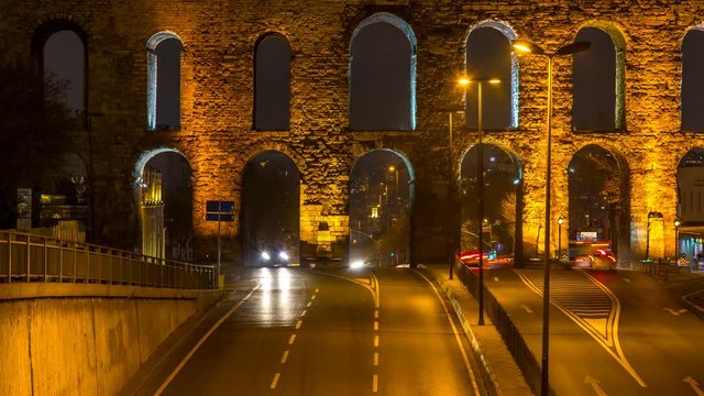 Time lapse clip near Valens Aqueduct (Bozdogan Su Kemeri) in evening with traffic of cars, Istanbul, Turkey. It was a water-providing system of the Eastern Roman capital Constantinpole