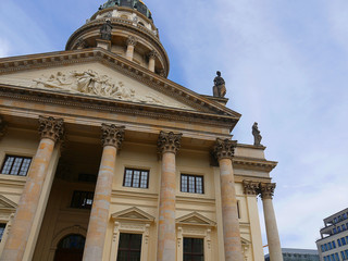 The Gendarmenmarkt is a square in Berlin  including the Konzerthaus and the French and German Churches. 
