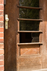 Broken glass window in door - crime, robbery, home invasion, abandoned