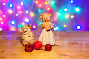  New Year background with christmas lights. Cute couple of funny pigs. Marriage concept.