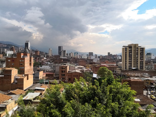 Obraz premium View of the center of Medellin, Colombia with high buildings of industry, commerce and finance. Partly cloudy day.