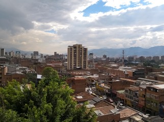 Obraz premium Medellin, Colombia, downtown with brick buildings and concept of development and strength. Partly cloudy day with lots of sunlight.