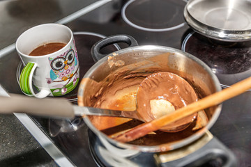 Pot where chocolate has been made, next to a  bowl