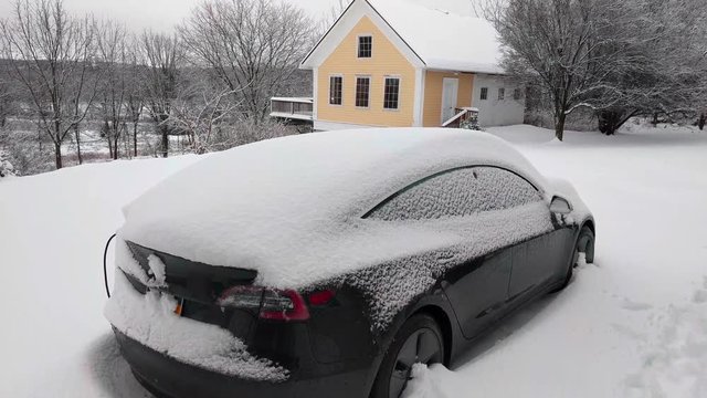 EV charging in the snow with no logos visible