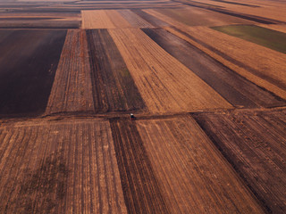 Aerial view of agricultural tractor doing stubble tillage