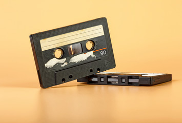 Fototapeta premium Two vintage audio cassette on brown background