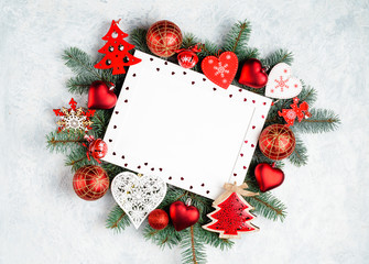 Fototapeta na wymiar christmas or new year frame composition. christmas decorations in red colors on white background with empty copy space for text. holiday and celebration concept for postcard or invitation. top view