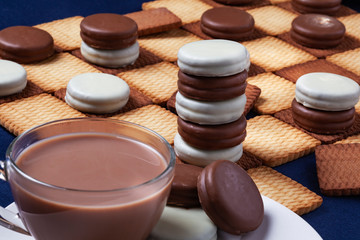Obraz na płótnie Canvas Cookie's checkers and a cup of coffee. Selective focus.