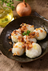 Meat stuffed potato dumplings with fried onion and greaves on top