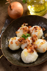 Meat stuffed potato dumplings with fried onion and greaves on top