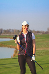 Young beautiful woman is training golf