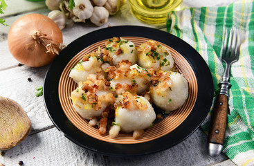 Meat stuffed potato dumplings with fried onion and greaves on top