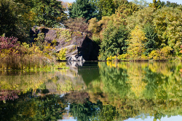 Fototapeta na wymiar Turtle Pond Reflections. The view across Turtle Pond in Central Park, New York City on a still autumn morning.