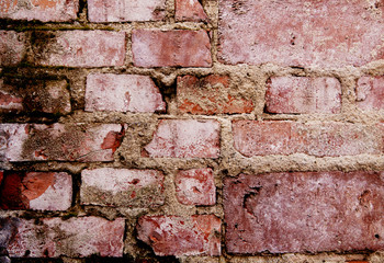 Detail of grunge brick wall background - weathered stone texture with cement