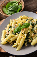 Penne pasta with spinach, gorgonzola cheese and walnuts