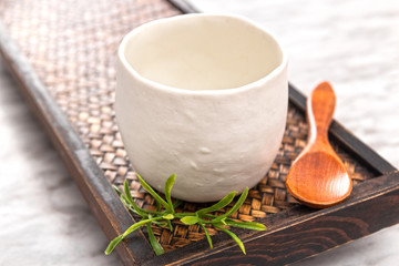 Ceramic teacup on a wooden tray