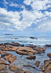 Tranquil seashore with erraticl shaped rocks, Sanya, Hainan Island, China