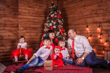 A large family gathered around the New Year tree. Merry Christmas and Happy New Year. parents and children.