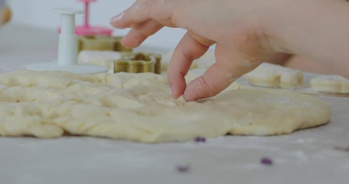 Little girl making cookies from dough