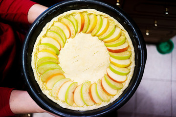 The process of cooking apple pie on a baking sheet.