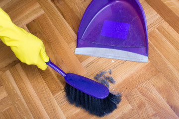 House keeper sweeping with dust pan
