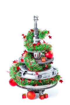 Abstract christmas tree of car parts on a white background. Decorated with Christmas toys, garland