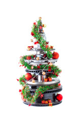 Abstract christmas tree of car parts on a white background. Decorated with Christmas toys, garland