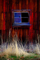 Old Barn in Field in Late Fall Autumn Brown Grass Weathered Red Wood