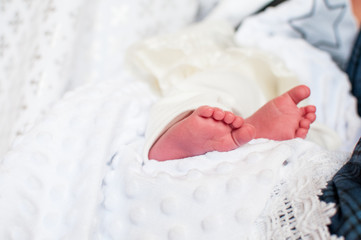 Fototapeta na wymiar christening legs of newborn child