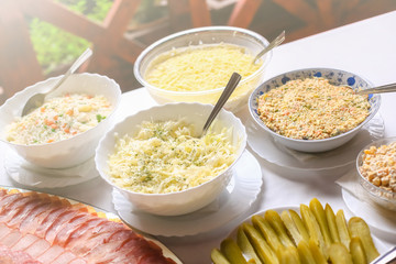 Different types of delicious salads. Wedding day food table.